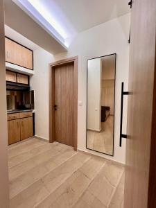 a hallway with a door and a mirror at Central Studio Semi-basement in Heraklio +10 photos