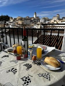 a table with a bottle of wine and a plate of food at Romantic house in Sedella in Sedella +18 photos