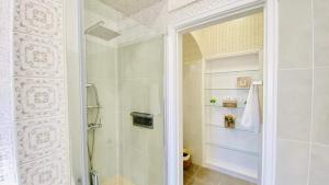 a bathroom with a shower and a glass door at Só Espeto Accommodation Rooms in Santa Cruz +34 photos