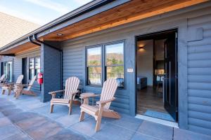 a patio with chairs and tables on a house at Cove Creek Lodge 209 Standard Double Queen Room in Oakland