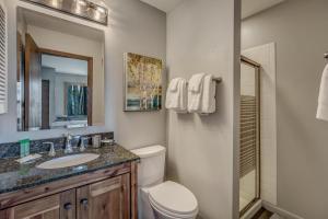 a bathroom with a toilet and a sink and a mirror at Mustang in Clark +21 photos