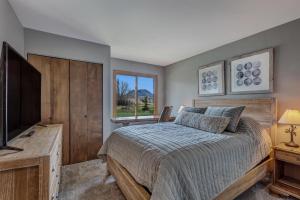 a bedroom with a bed and a flat screen tv at Mustang in Clark