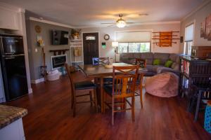 a kitchen and living room with a table and chairs at Peaceful Pine Place Cabin in Pine
