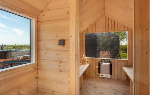 a sauna with a large window in a wooden house at Lovely Home In Ørsted With Wifi in Ørsted +24 photos