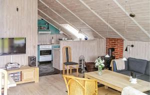 a living room with a couch and a table at Holiday Home Ternevej Ørsted Iii in Kare