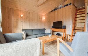 a living room with a couch and a table at Holiday Home Bork Hytteby Hemmet Denmark in Falen