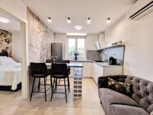 a kitchen and living room with a couch and a table at MonLux studio- FREE Public Parking-Easy Walk to the Center in Split