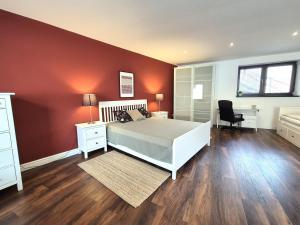 a bedroom with a bed and a red wall at Apartment Zoe - Old Town in Bratislava