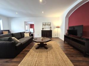 a living room with a couch and a flat screen tv at Apartment Zoe - Old Town in Bratislava