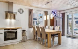 a kitchen with a wooden table and chairs at Ferienhaus 34 Altefähr in Altefähr