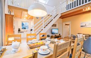 a dining room and living room with a table and chairs at Seebrise in Süssau