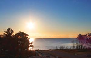 a sunset over the ocean with the sun setting at Eden in Binz +36 photos
