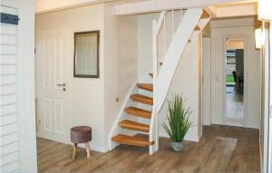 a white staircase in a home with a plant at Gorgeous Home In Dagebüll With Sauna in Dagebüll
