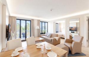 a living room with a table and chairs and a bedroom at Princess in Binz