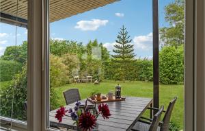 a dining room table with a view of a yard at Stunning Home In Bogense With Wifi in Bogense