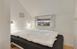 a large white bed in a room with a window at Gorgeous Home In Hejls With Wifi in Hejls +13 photos