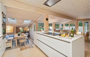 an open kitchen and living room with a counter top at Stunning Home In Nexø With Kitchen in Vester Sømarken +18 photos