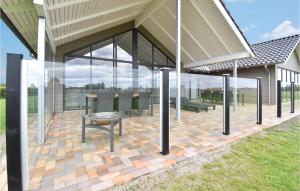 a pavilion with tables and chairs on a brick patio at Beautiful Home In Otterup With Sauna in Otterup +27 photos
