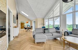 a living room with two couches and a table at Beautiful Home In Otterup With Sauna in Otterup