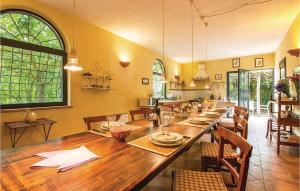 a dining room with a long wooden table with chairs at Villa Lavinia in Vitorchiano +24 photos