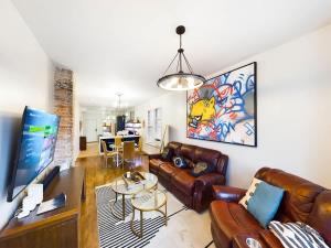 a living room with a couch and a table at Chi-Town Ultimate Hideout 1-2-3 in Berwyn