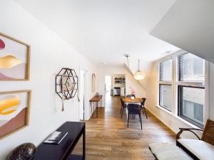 a living room with a table and a dining room at Chi-Town Ultimate Hideout 1-2-3 in Berwyn