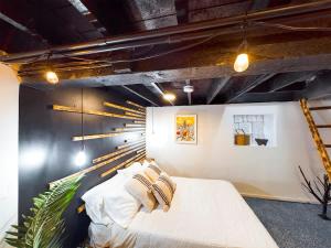 a bedroom with a white bed with pillows on it at Chi-Town Ultimate Hideout 1-2-3 in Berwyn