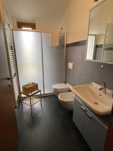 a bathroom with a toilet and a sink at Cav Pop Sky in Seregno