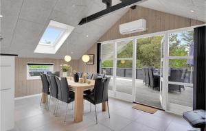 a dining room with a table and chairs at Holiday Home Bjergbovej Blåvand Denm in Blåvand