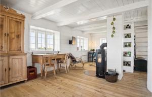 a kitchen with a wooden table and a wooden floor at 3 Bedroom Gorgeous Home In Blåvand in Blåvand