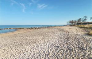 a sandy beach with the ocean in the background at Strandblick 28 in Schönhagen