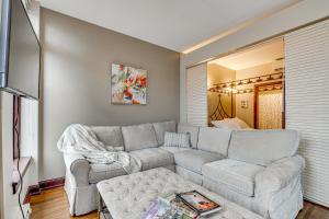 a living room with a couch and a tv at Walk to Convention Center, Secured Apt in Columbus in Columbus