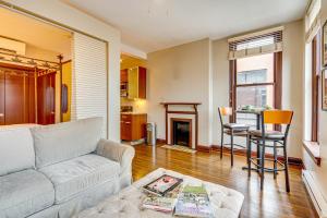 a living room with a couch and a table at Walk to Convention Center, Secured Apt in Columbus in Columbus
