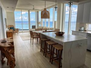 a kitchen and living room with a view of the ocean at 3-Bedroom Condo with ocean view in George Town