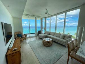 a living room with a couch and a view of the ocean at 3-Bedroom Condo with ocean view in George Town