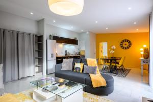 a living room with a couch and a table at Le Charles in Montbéliard