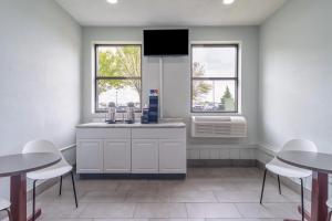 a kitchen with two tables and a sink and two windows at Motel 6 - Franklin, OH in Franklin