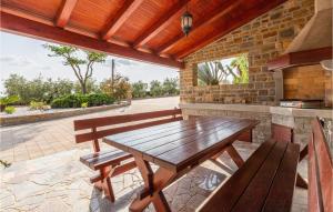a wooden table and benches on a patio at 1 Bedroom Amazing Apartment In Secovlje in Sečovlje +12 photos