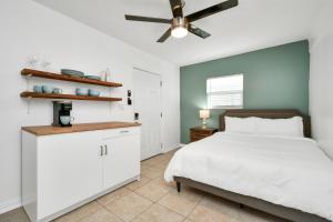 a bedroom with a bed and a ceiling fan at Cozy MiniStudio with Queen Bed Coffee in Cypress