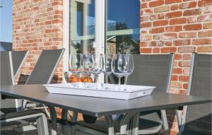a black table with wine glasses on top of it at Stunning Home In Dagebüll With Sauna in Dagebüll