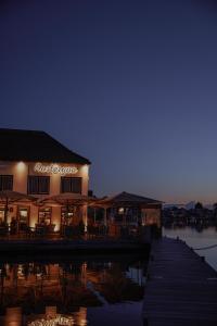 a building with a dock next to a body of water at Hotel Oostergoo in Grou