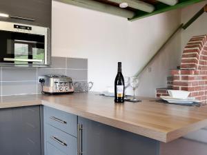 a bottle of wine sitting on a counter in a kitchen at Darci's Lodge - Uk1297 in Threlkeld