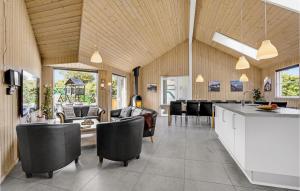 a kitchen and living room with a table and chairs at Nice Home In Sydals With Sauna in Høruphav
