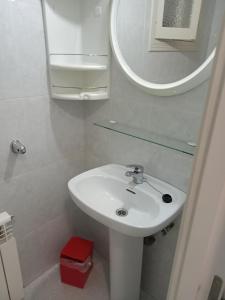 a bathroom with a white sink and a mirror at El Campello 1H2C in El Campello +30 photos