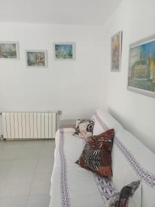 a white couch sitting in a living room with pillows at El Campello 1H2C in El Campello
