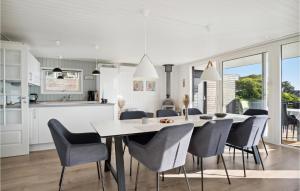 a kitchen and dining room with a table and chairs at 4 Bedroom Nice Home In Børkop in Børkop