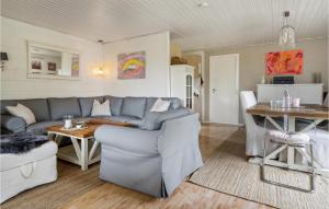 a living room with a couch and a table at Gorgeous Home In Væggerløse With Wifi in Marielyst