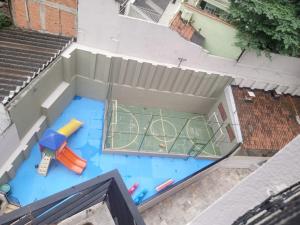 een uitzicht over een zwembad met een tennisbaan bij inegociável por 3 anos in Sao Paulo