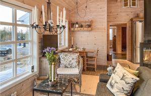 a log cabin living room with a table and chairs at Nice Home In Veggli With Wifi in Veggli