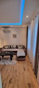 a living room with a couch and a table at Apartman Magic house in Kruševac +11 photos